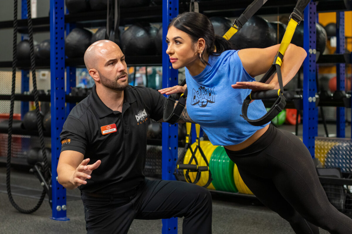 Crunch Fitness Trainer working with client