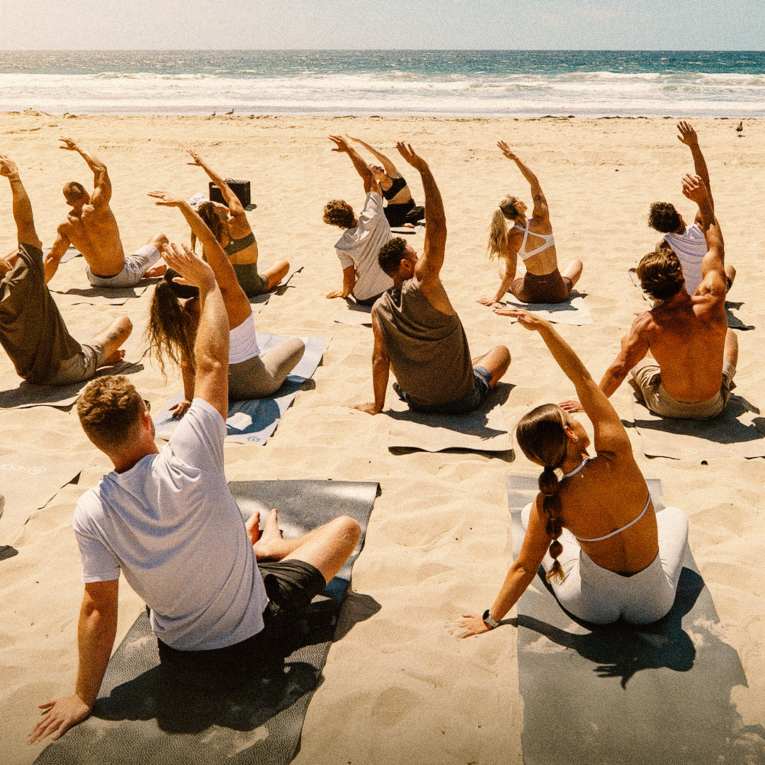 Group yoga on the beach