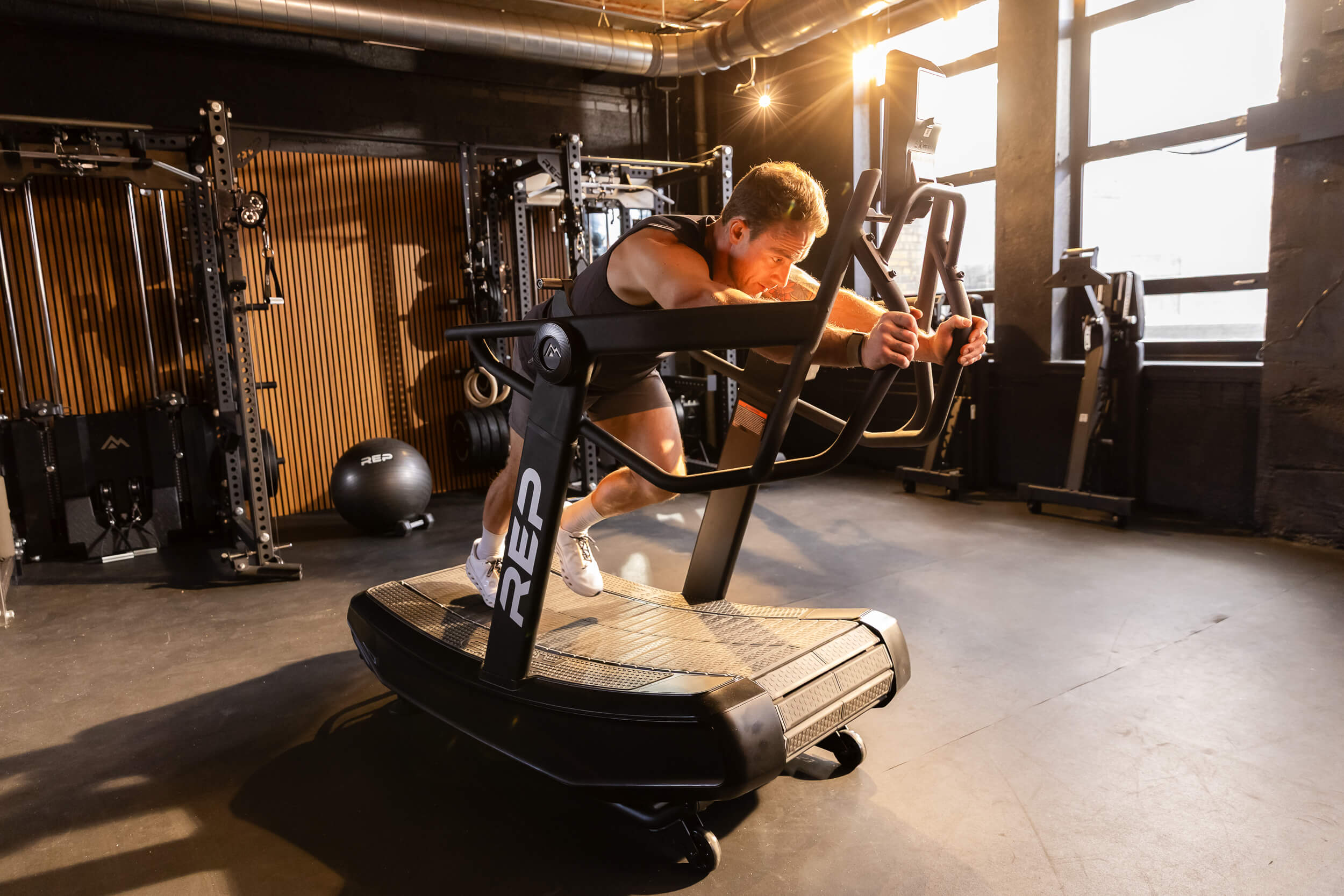 Man using the Strive™ Curved Treadmill