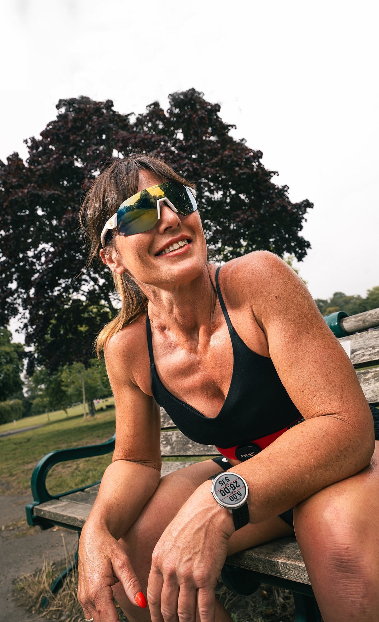 Athletic female sitting on a bench with a Myzone wrist wearable