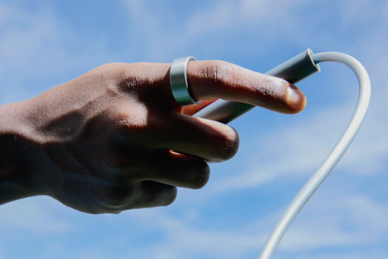 Hand wearing an Ultrahuman ring holding a jump rope