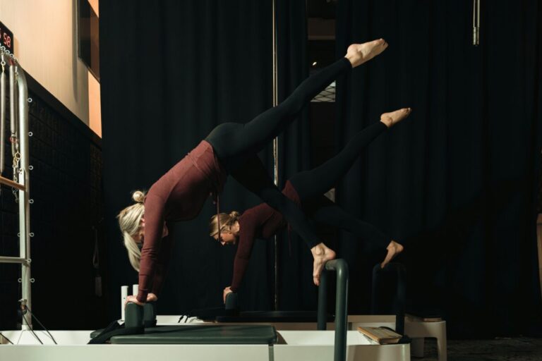 Women practicing Pilates on a reformer