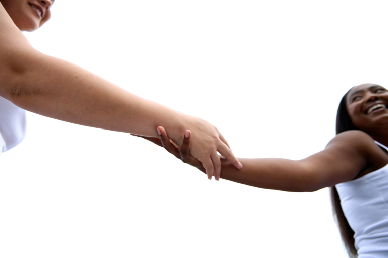 Two women holding hands