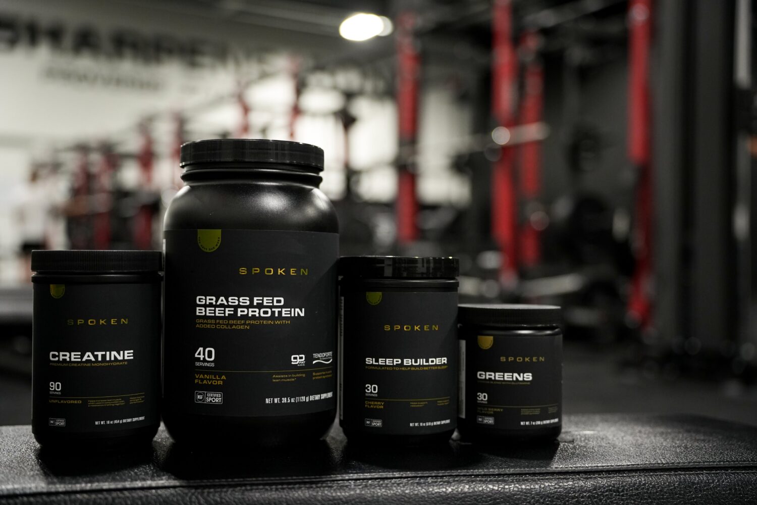 Spoken Nutrition supplement bottles in a gym