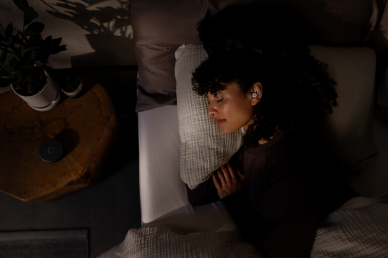 Female sleeping with Ozlo Sleepbuds