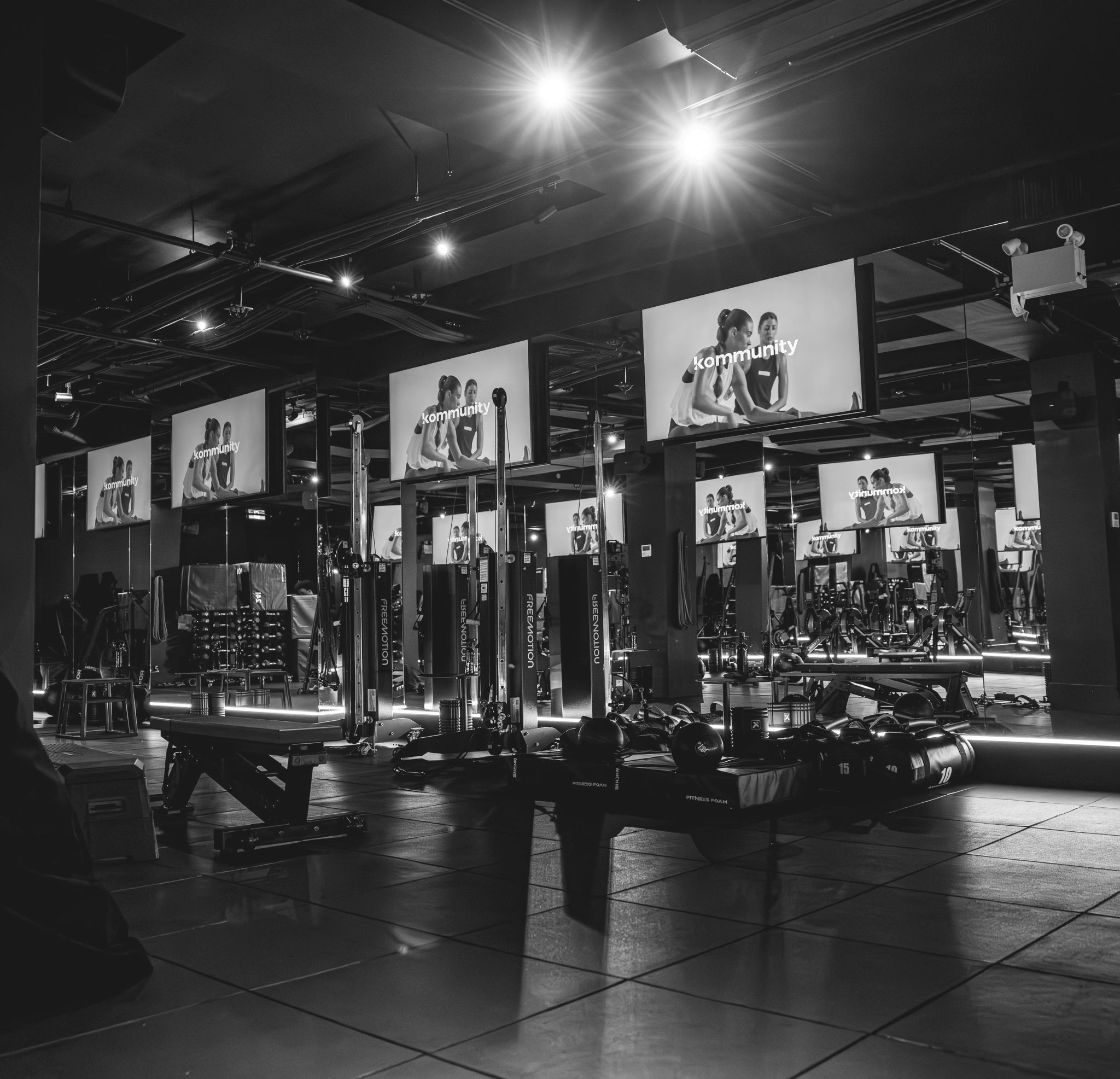 Black and white photo of a Kommunity Fitness gym floor