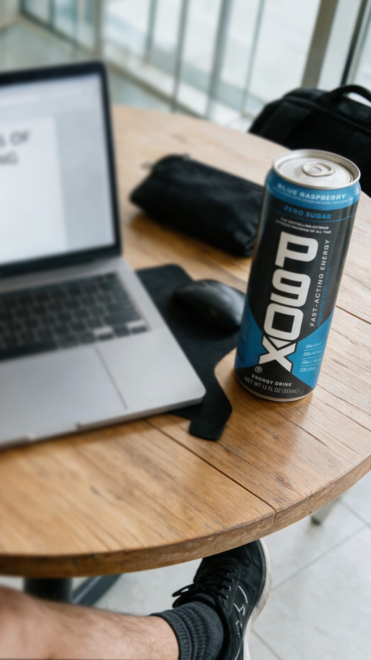P90X energy drink next to a laptop