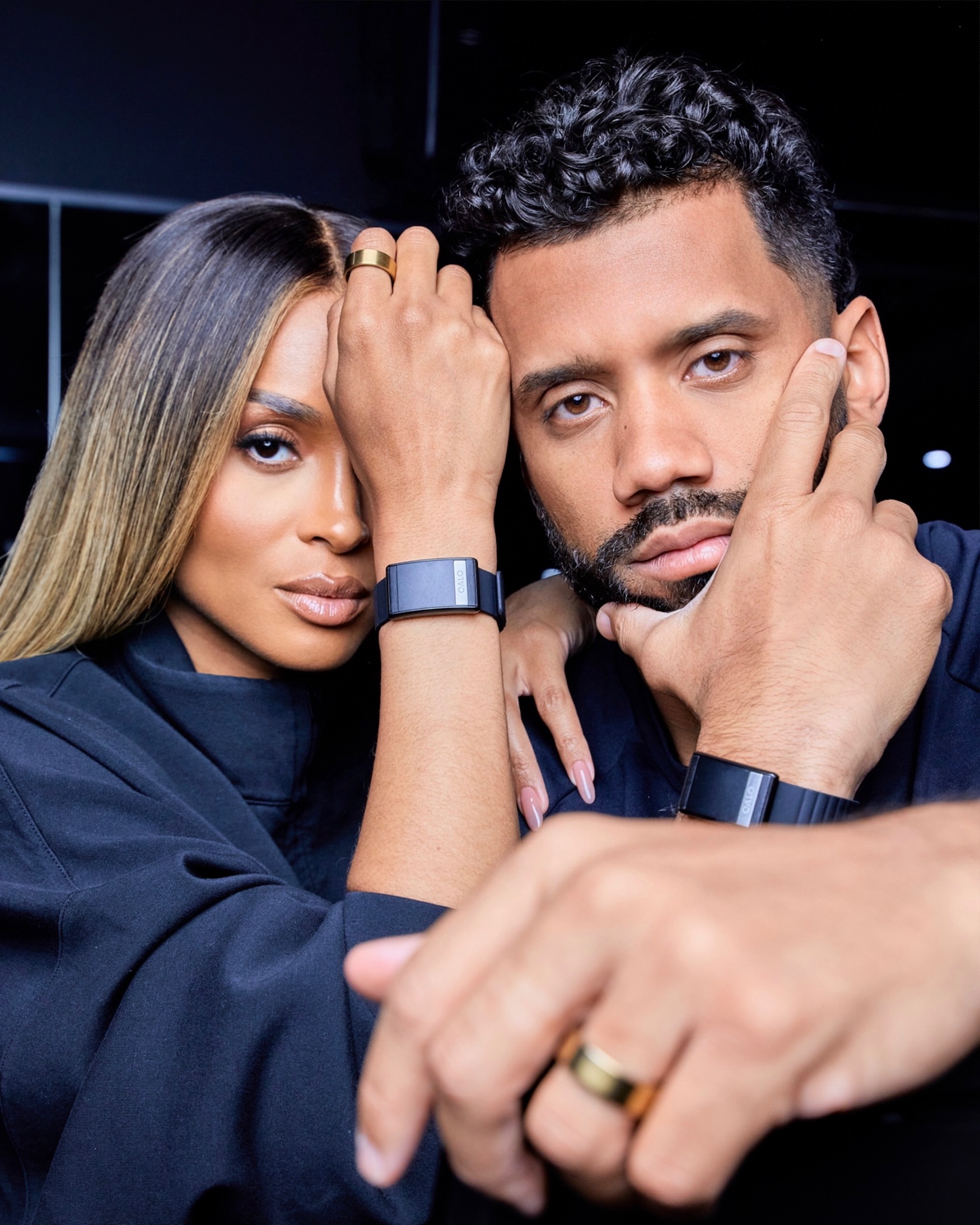 Russell Wilson and Ciara headshot wearing QALO products